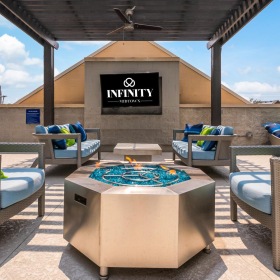 Settle into comfort at Infinity Midtown a group of lounge chairs outside a building