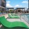 a pool with lounge chairs and tables by it